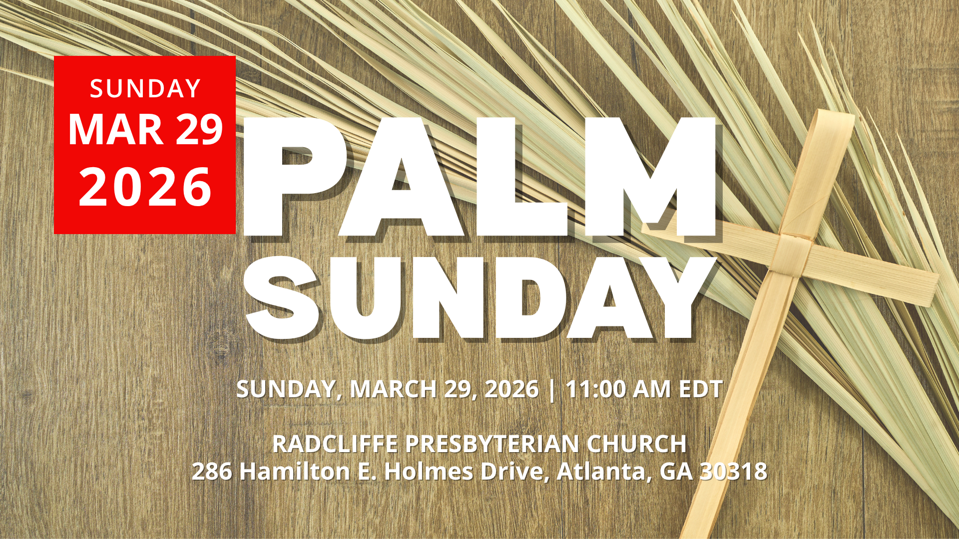 Close-up of palm branches and a handmade palm cross on a wooden background.